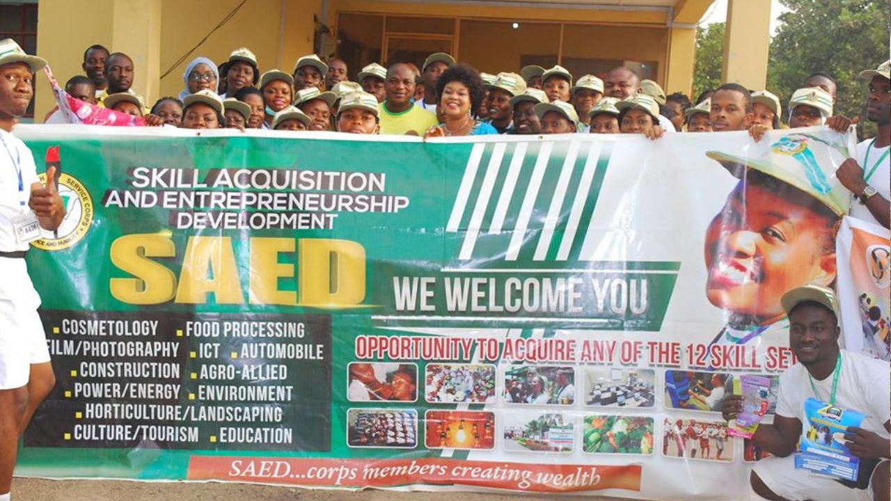 NYSC Corpers holding a banner during SAED Workshop