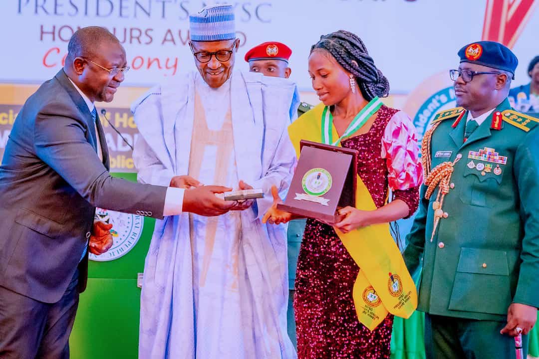 NYSC member shaking hands with the President