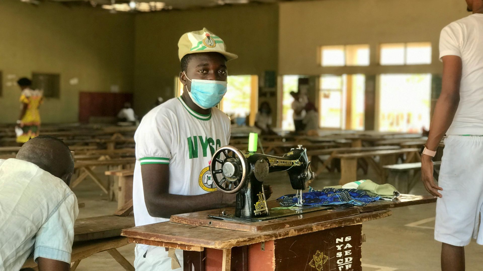 A young Nigerian corps member sewing